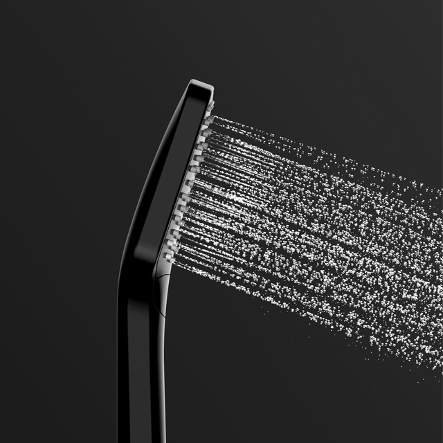 Close-up of black handheld shower head spraying water