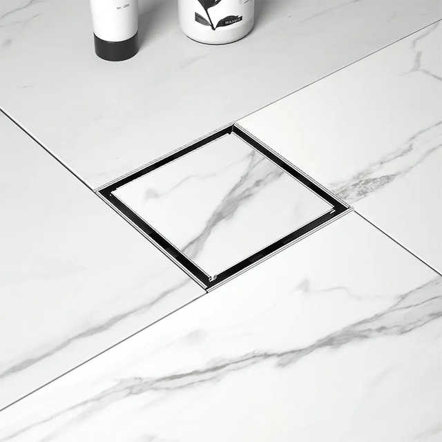 Invisible floor drain installed in modern white marble bathroom tiles