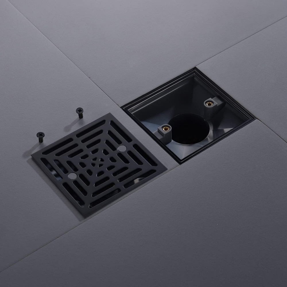 Square black shower drain with removed grate showing access to vertical drains