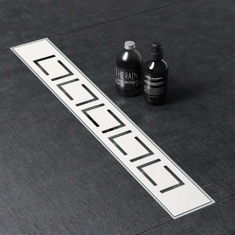 Minimalist linear shower drain seamlessly integrated into dark stone bathroom tiles