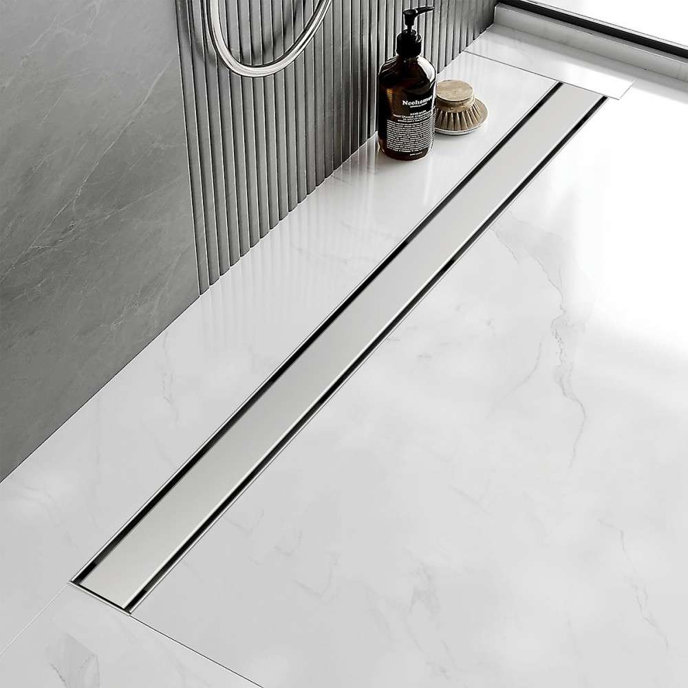 Rectangle shower drain flush mounted in white marble bathroom floor