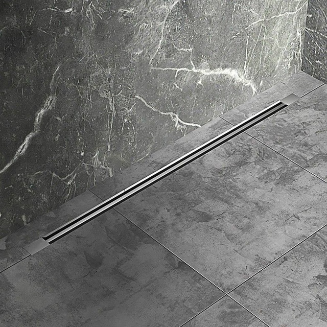 Linear drain shower installed in grey stone tiled bathroom floor