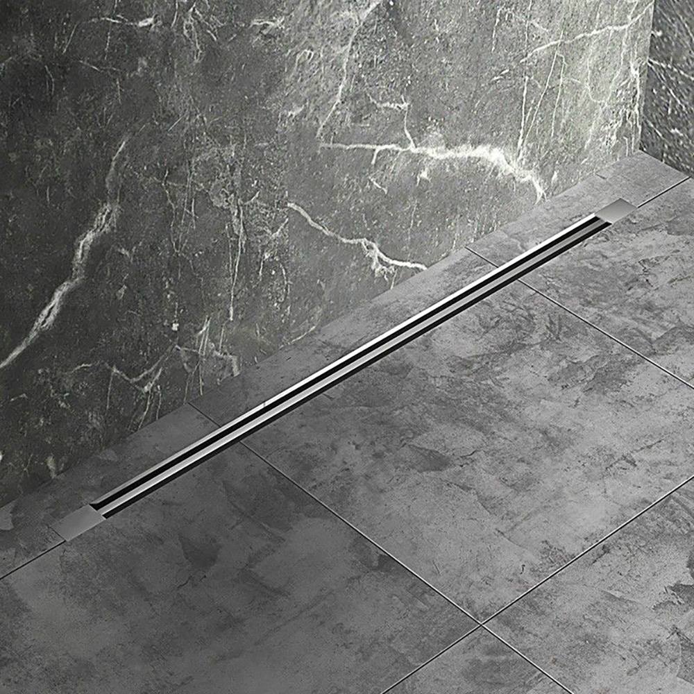Linear drain shower installed in grey stone tiled bathroom floor