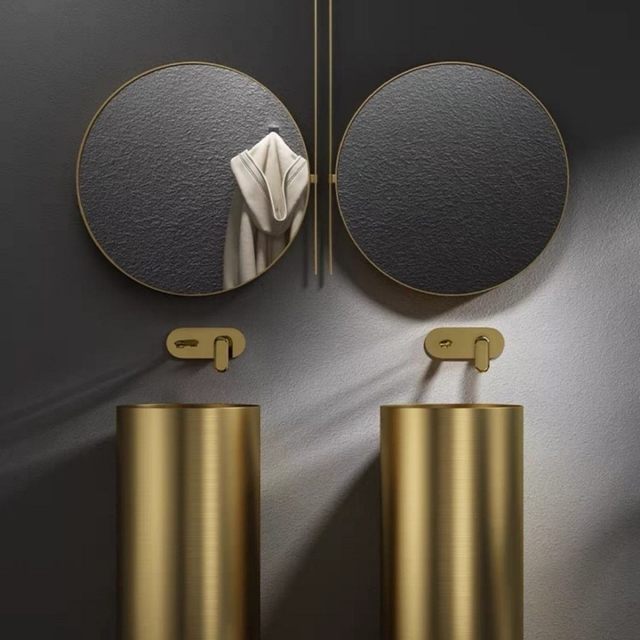 Round full pedestal wash basin in gold finish for luxury bathroom interior