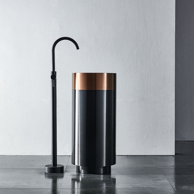 Modern freestanding stainless steel pedestal sink in minimalist bathroom scene