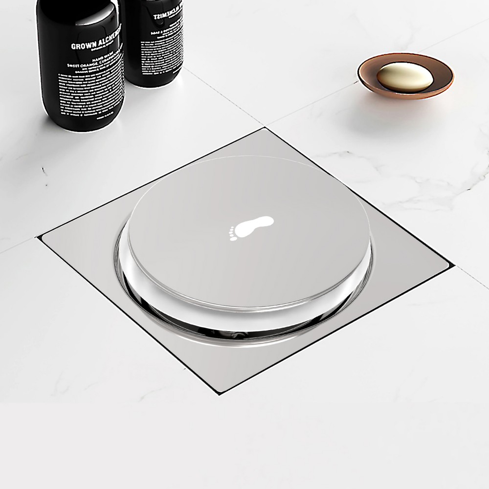 Luxury bathroom scene featuring a flush-mounted square tile drain installed in white marble flooring