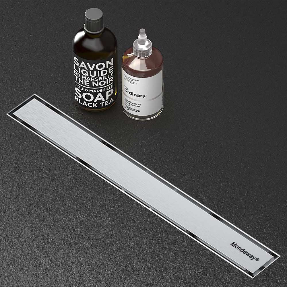 Installed linear shower drains in a modern wet room with anti-clogging performance