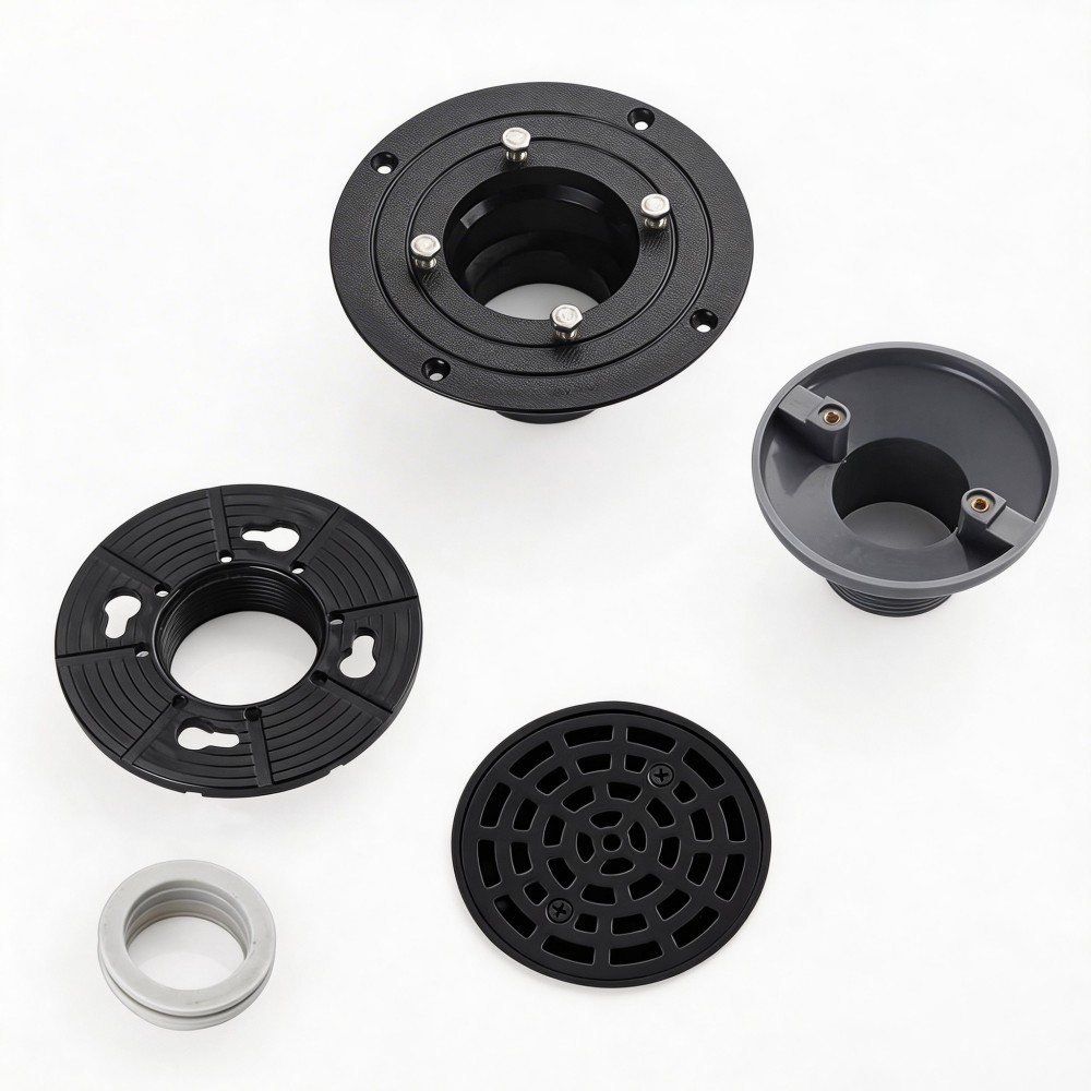 Disassembled round shower drain cover showing stainless steel grate and ABS PVC flange components