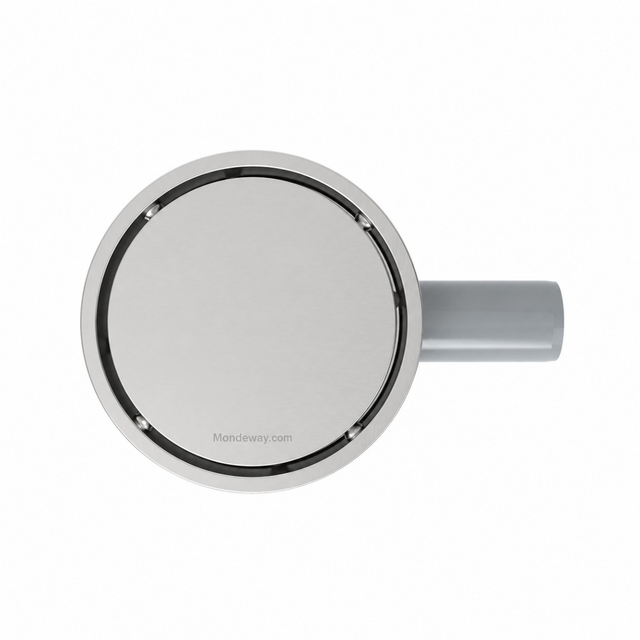 Top angle of round shower drain showcasing solid seamless metal cover