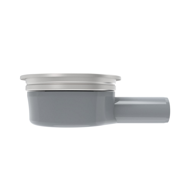 Low profile side profile of a horizontal floor drain paired with a solid round shower floor drain top